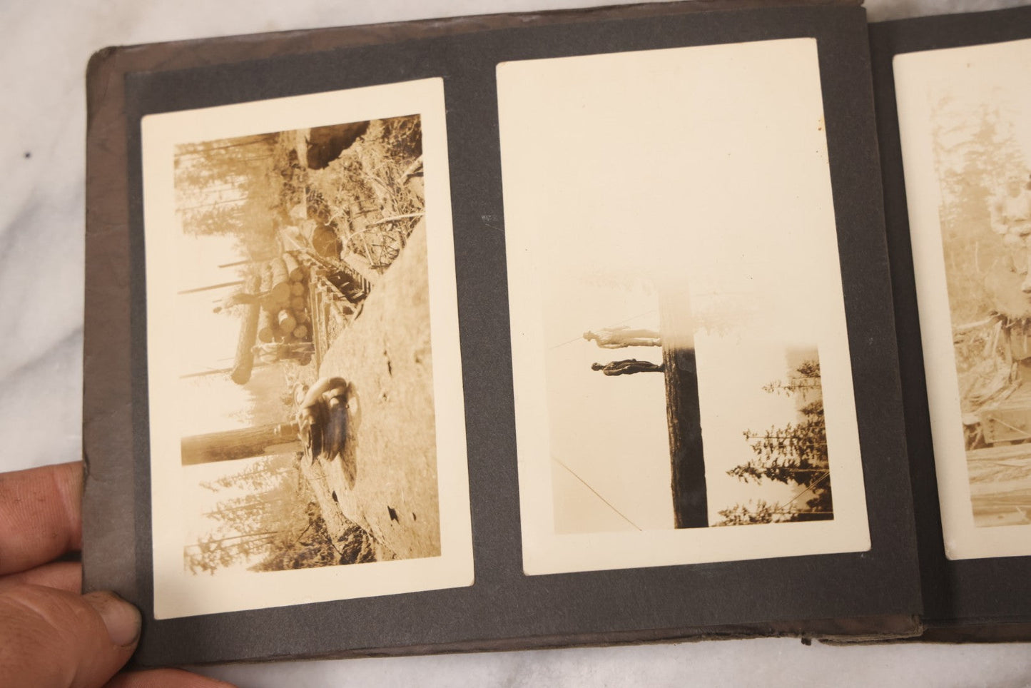 Lot 031 - Vintage Snapshot Photo Album With 46 Snapshot Photographs Including Occupational Photos Of Loggers At Work, Photos Of Children, Mountains, Rivers, And Other Vernacular Photos, Circa 1920s