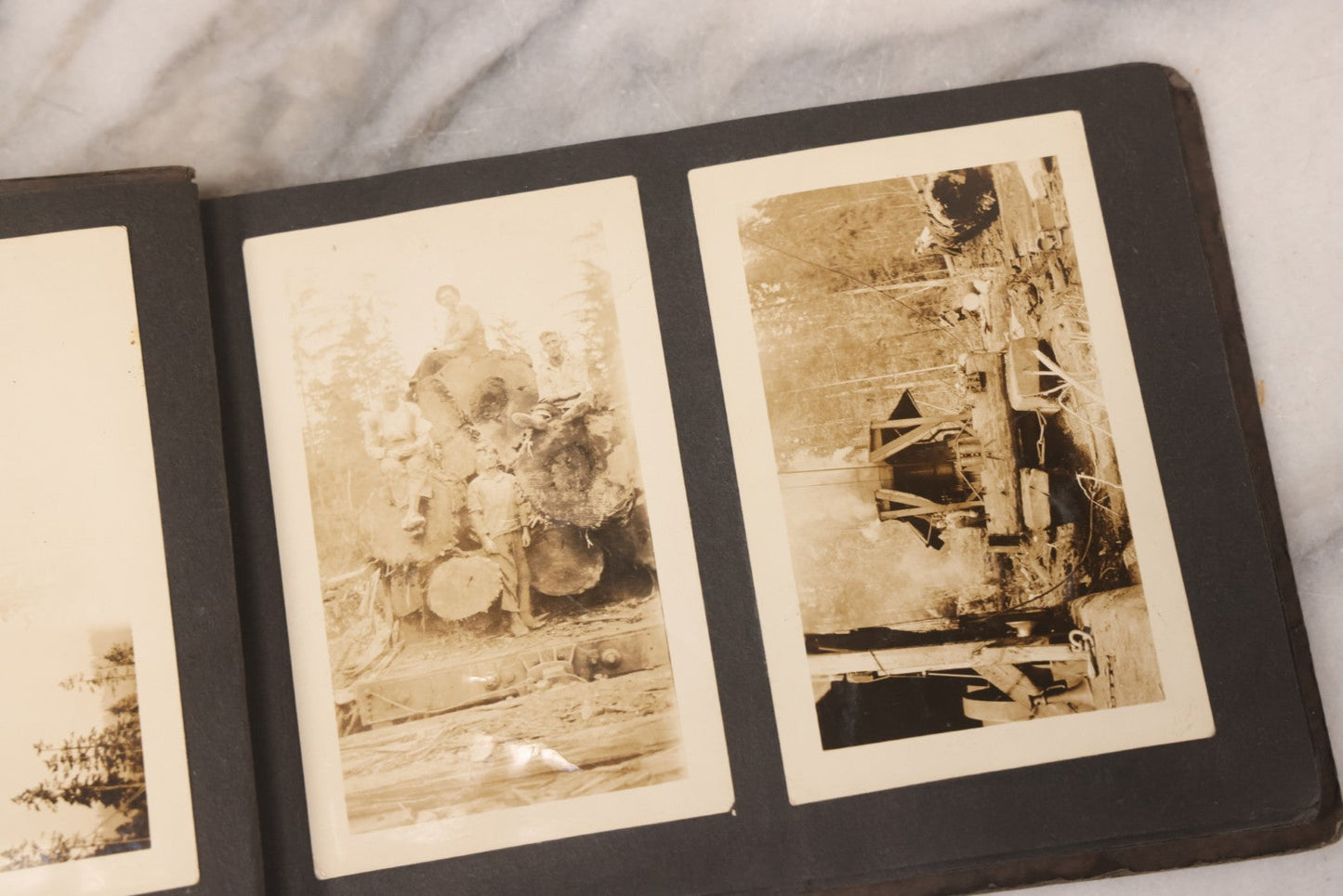 Lot 031 - Vintage Snapshot Photo Album With 46 Snapshot Photographs Including Occupational Photos Of Loggers At Work, Photos Of Children, Mountains, Rivers, And Other Vernacular Photos, Circa 1920s
