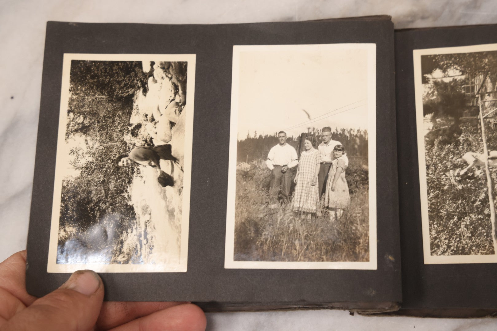 Lot 031 - Vintage Snapshot Photo Album With 46 Snapshot Photographs Including Occupational Photos Of Loggers At Work, Photos Of Children, Mountains, Rivers, And Other Vernacular Photos, Circa 1920s