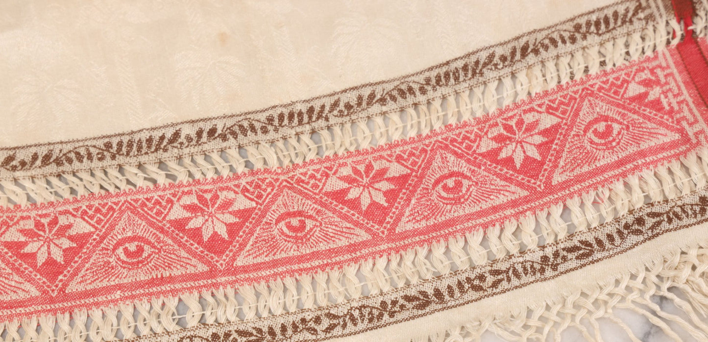 Lot 035 - Antique Damask Textile Fabric Bib With Detailed Red Embroidery Featuring All Seeing Eye, Comb And Brush And Hairpin Motifs