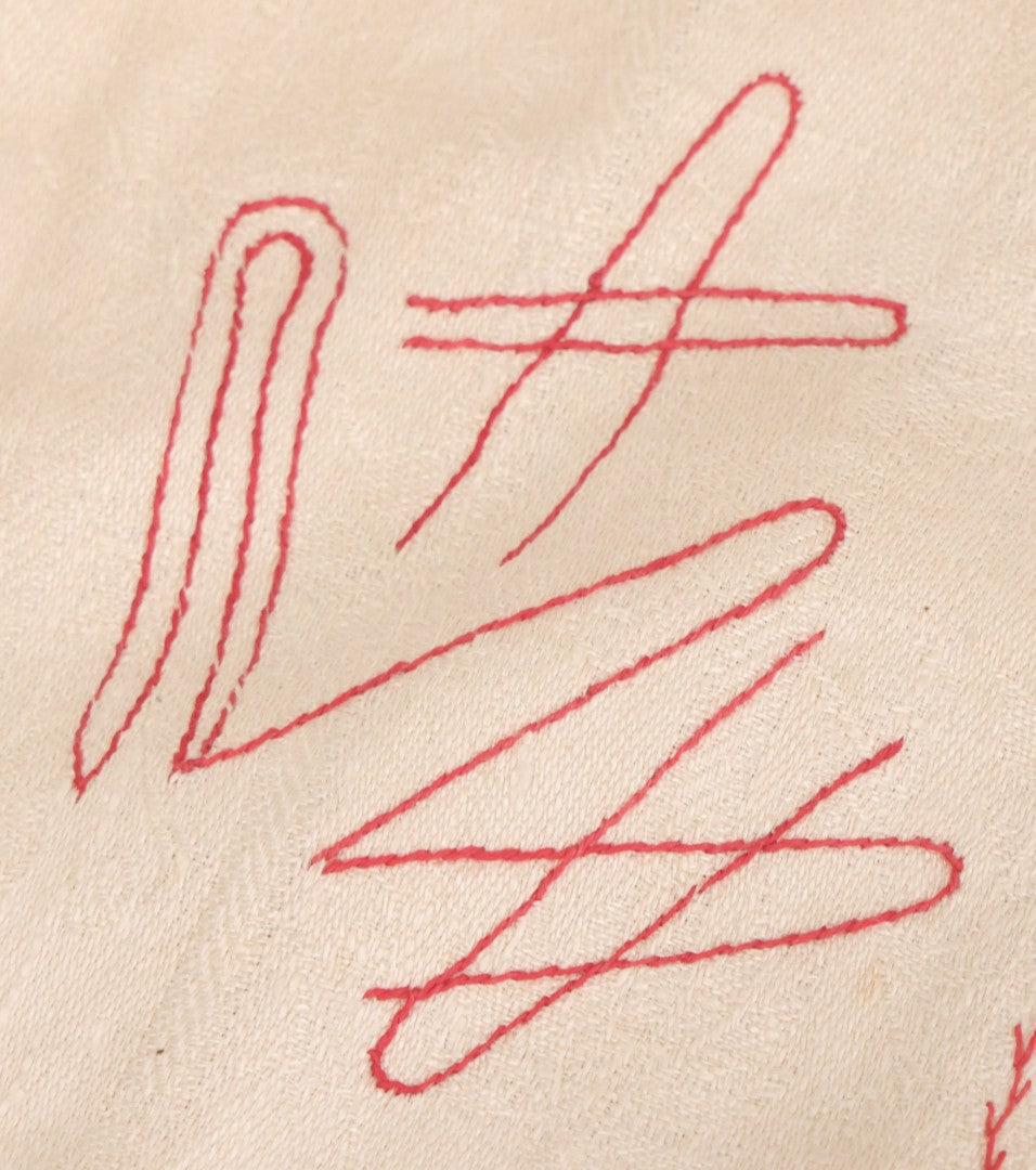 Lot 035 - Antique Damask Textile Fabric Bib With Detailed Red Embroidery Featuring All Seeing Eye, Comb And Brush And Hairpin Motifs