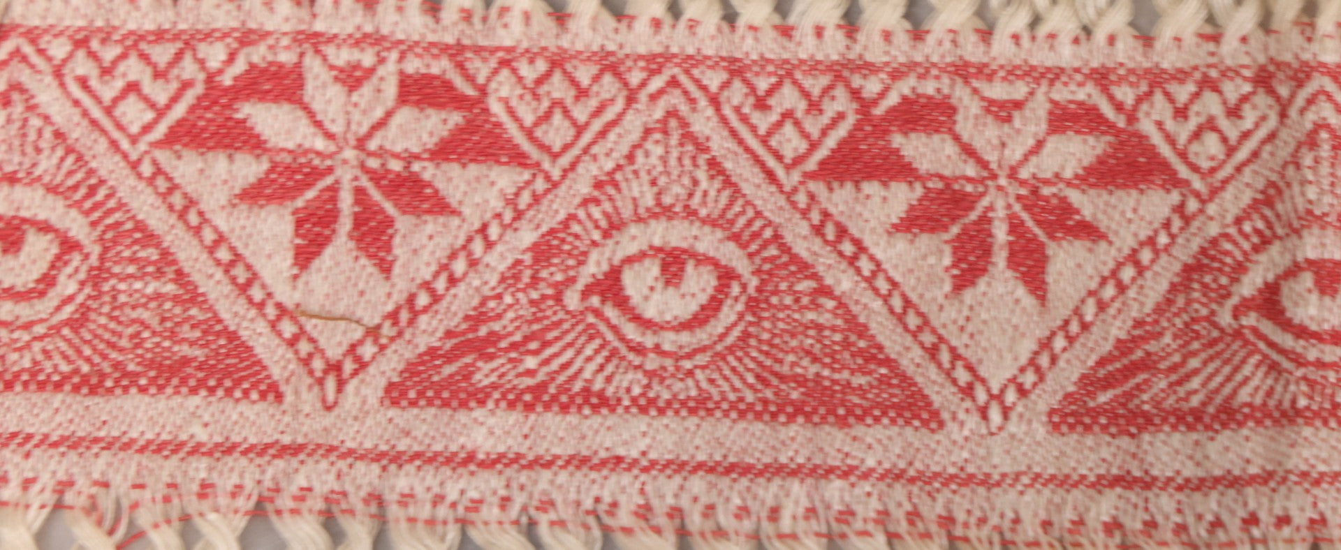 Lot 035 - Antique Damask Textile Fabric Bib With Detailed Red Embroidery Featuring All Seeing Eye, Comb And Brush And Hairpin Motifs