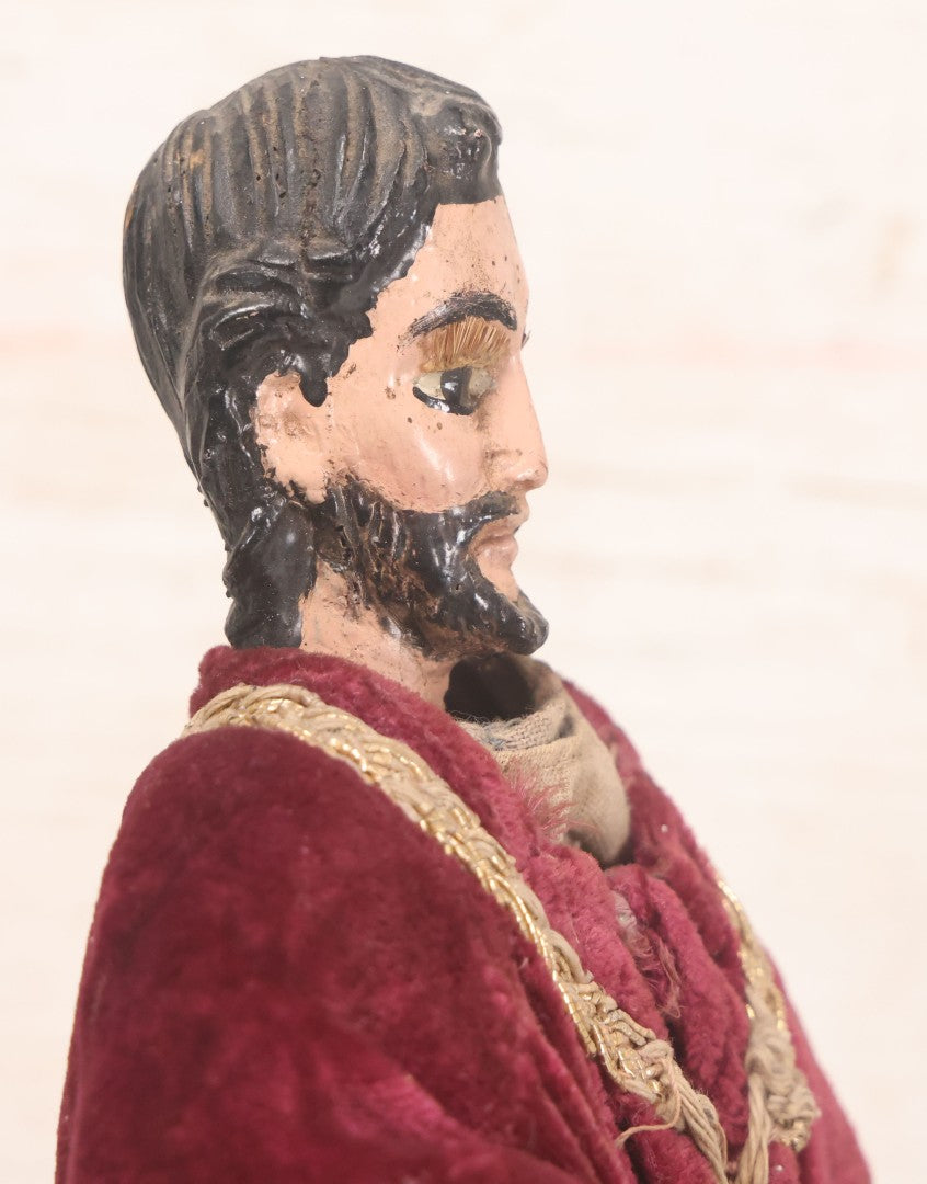 Lot 047 - Antique Handmade Religious Saint Statue Santos Figure With Carved Wooden Head, Hand And Feet, Original Paint, Real Hair Eyebrows, And Maroon Velvet Robe, Note Missing Hand, 16" H
