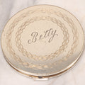 Lot 063 - Vintage Regent Brand Circular Compact With "Betty" Engraved On Lid And Original Pad And Mirror, 4" Diameter