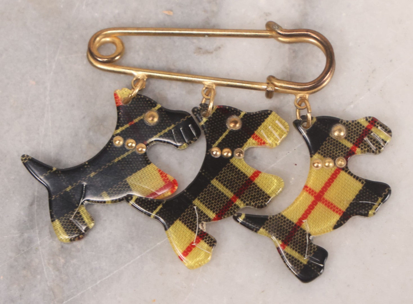 Lot 065 - Vintage Yellow And Black Tartan Scottie Dog Pin With Three Charms