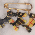 Lot 065 - Vintage Yellow And Black Tartan Scottie Dog Pin With Three Charms