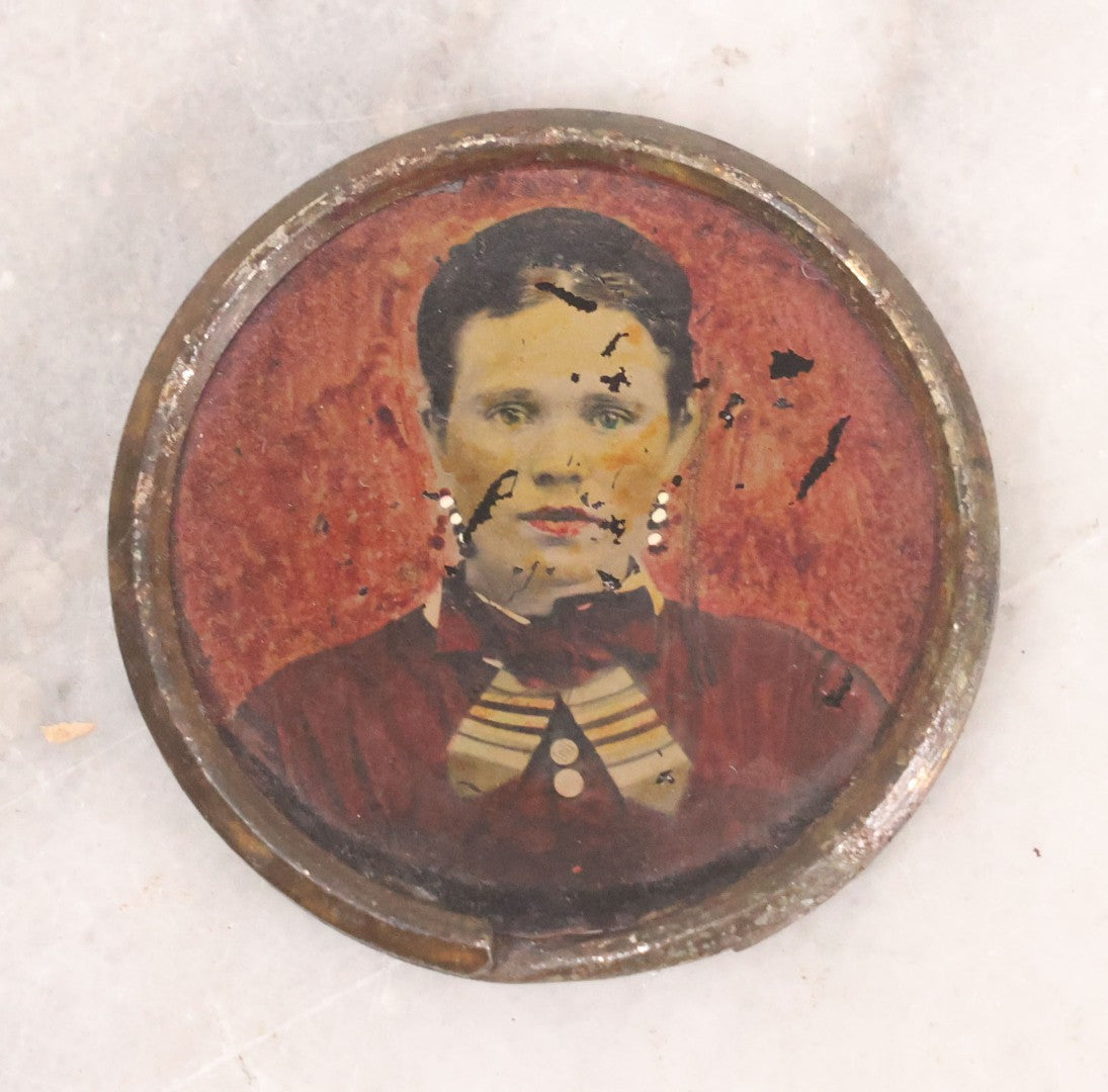 Lot 070 - Antique Painted Tintype Of Woman, Key Ring Souvenir, With Paper Identification In French On Verso, Illegible Due To Paper Loss, 1-1/2" Diameter