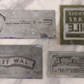 Lot 077 - Grouping Of Four Vintage Metal Printing Plates Including Loveable Brassieres, Surgeons & Physicians Supply Co., Jaw Teasers, And Fragile Stamp