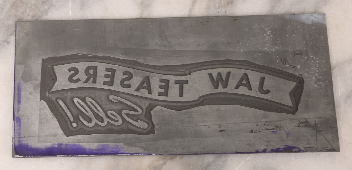 Lot 077 - Grouping Of Four Vintage Metal Printing Plates Including Loveable Brassieres, Surgeons & Physicians Supply Co., Jaw Teasers, And Fragile Stamp