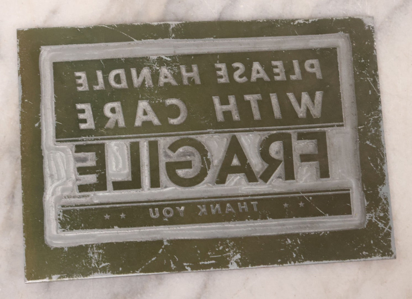 Lot 077 - Grouping Of Four Vintage Metal Printing Plates Including Loveable Brassieres, Surgeons & Physicians Supply Co., Jaw Teasers, And Fragile Stamp