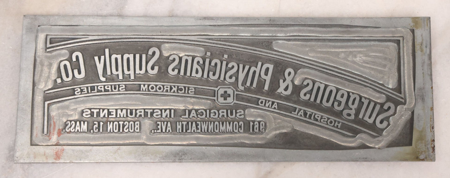 Lot 077 - Grouping Of Four Vintage Metal Printing Plates Including Loveable Brassieres, Surgeons & Physicians Supply Co., Jaw Teasers, And Fragile Stamp