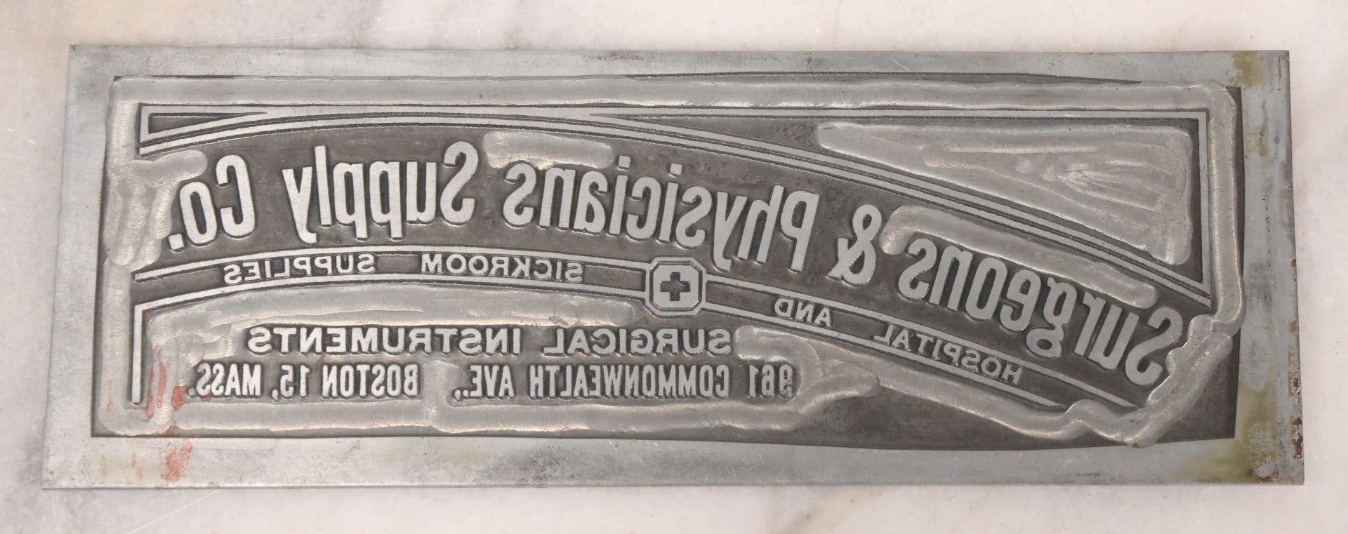 Lot 077 - Grouping Of Four Vintage Metal Printing Plates Including Loveable Brassieres, Surgeons & Physicians Supply Co., Jaw Teasers, And Fragile Stamp