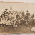 Lot 081 - Antique Trimmed Boarded Photograph Of Patriotic Celebration, Likely Independence Day, With Many Children In Costume Posing With American Flags And Two Adult Women