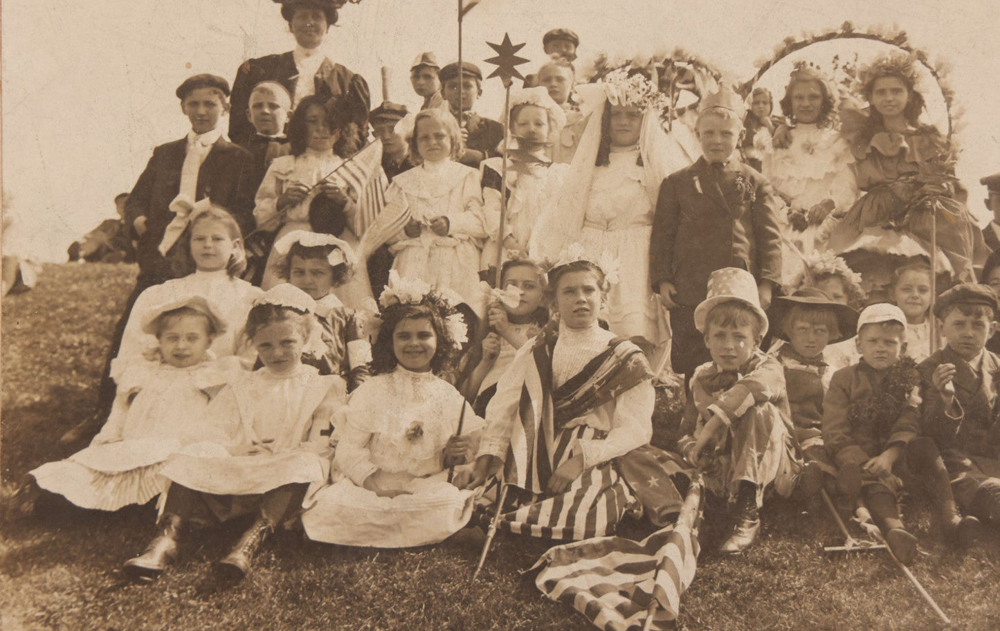 Lot 081 - Antique Trimmed Boarded Photograph Of Patriotic Celebration, Likely Independence Day, With Many Children In Costume Posing With American Flags And Two Adult Women