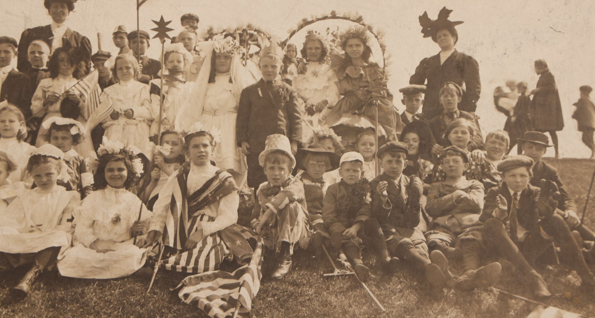 Lot 081 - Antique Trimmed Boarded Photograph Of Patriotic Celebration, Likely Independence Day, With Many Children In Costume Posing With American Flags And Two Adult Women