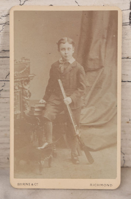 Lot 084 - Antique Carte De Visite C.D.V. Photograph Of Young Boy Posing With Rifle, Byrne & Co. Photographers To Her Majesty, Hill Street, Richmond, England