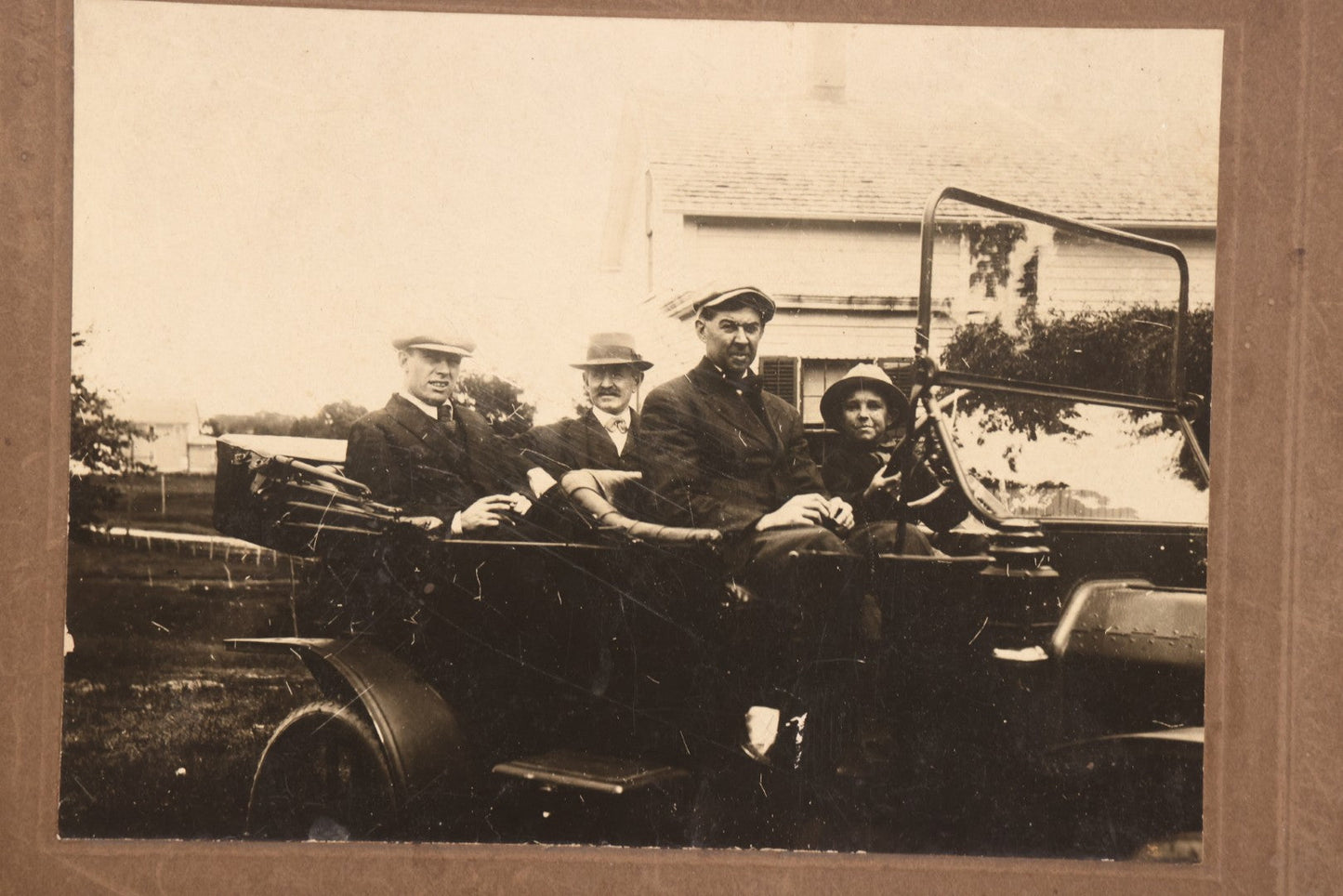 Lot 090 - Antique Boarded Photograph Of Three Men And Young Boy In Hats Driving In Early Automobile