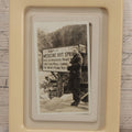 Lot 094 - Vintage Snapshot Photograph Of Man In Glasses Posing Beside Sign For Medicine Hot Springs, In Celluloid Frame