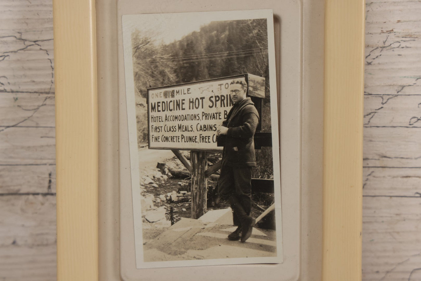Lot 094 - Vintage Snapshot Photograph Of Man In Glasses Posing Beside Sign For Medicine Hot Springs, In Celluloid Frame