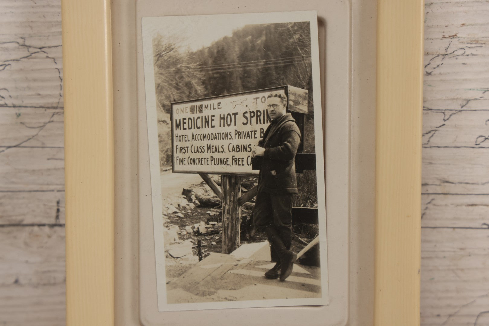 Lot 094 - Vintage Snapshot Photograph Of Man In Glasses Posing Beside Sign For Medicine Hot Springs, In Celluloid Frame