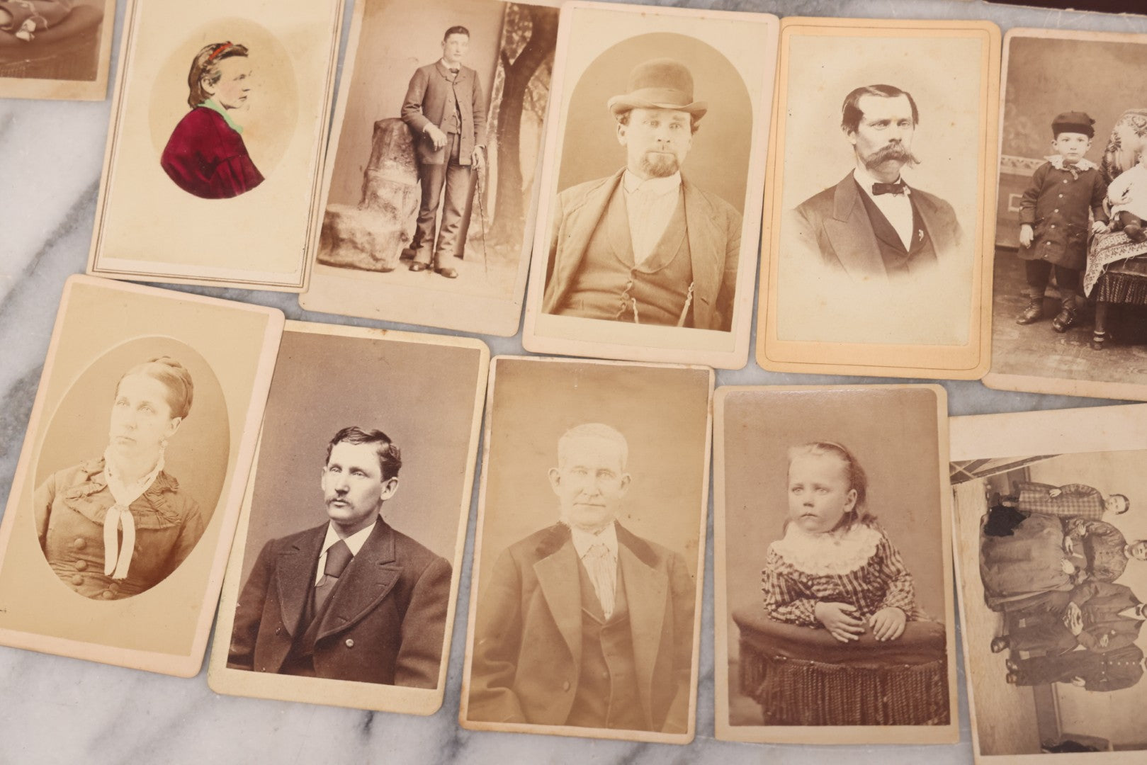 Lot 097 - Grouping Of 41 Carte De Visite C.D.V. Photographs Including Man In Bowler Hat, Man With Stick Cane, And Young Woman With Purple Tinted Dress