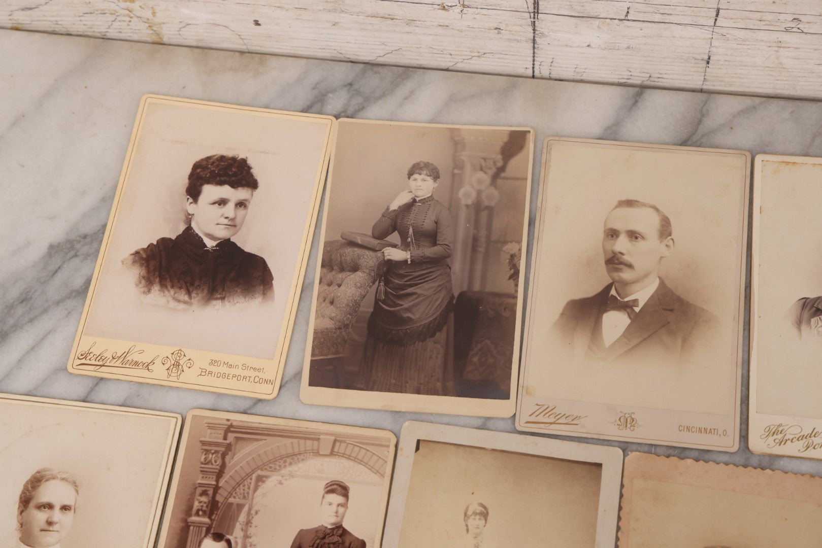Lot 099 - Grouping Of 19 Antique Cabinet Card Photographs Including Cute Smiling Baby, Three Well Dressed Young Men, And Woman Posing With Photo Album