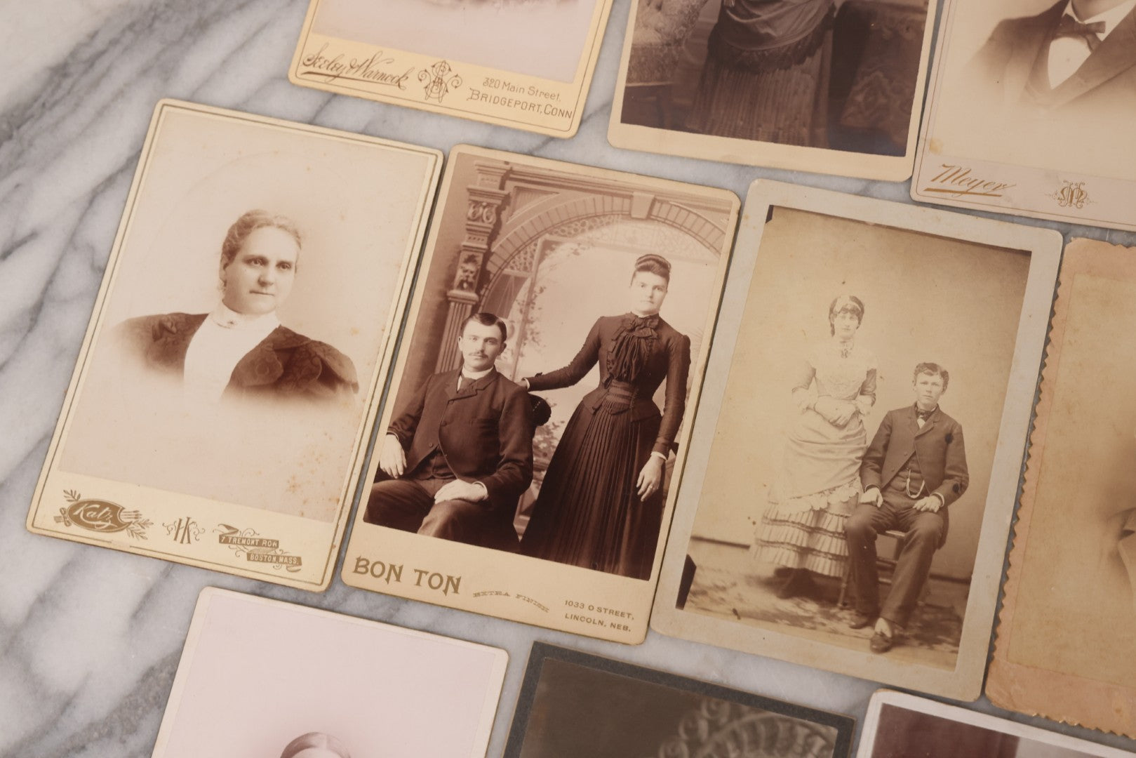 Lot 099 - Grouping Of 19 Antique Cabinet Card Photographs Including Cute Smiling Baby, Three Well Dressed Young Men, And Woman Posing With Photo Album