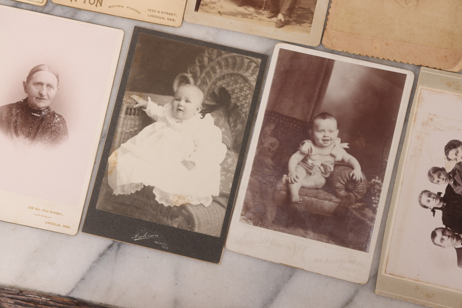 Lot 099 - Grouping Of 19 Antique Cabinet Card Photographs Including Cute Smiling Baby, Three Well Dressed Young Men, And Woman Posing With Photo Album