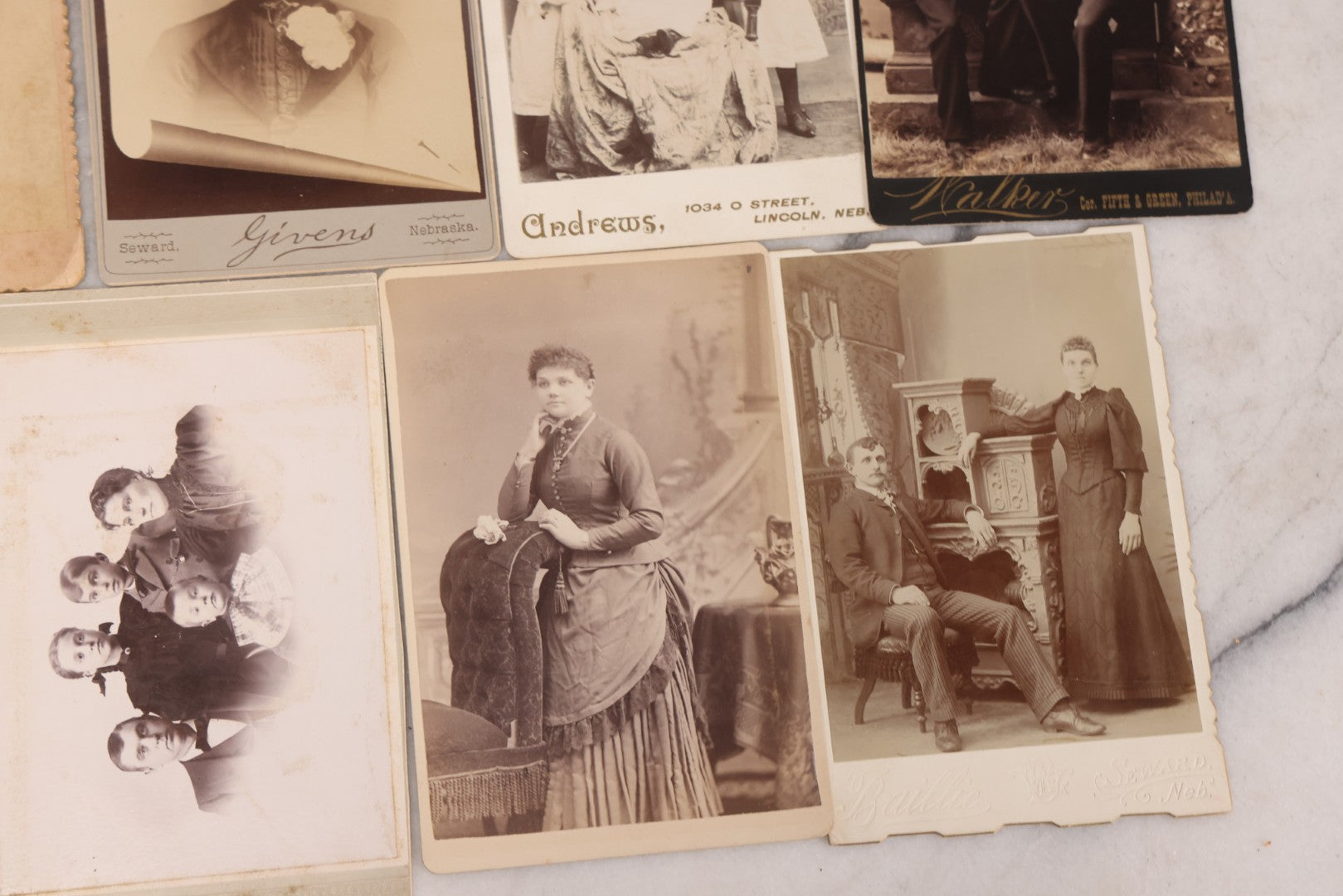 Lot 099 - Grouping Of 19 Antique Cabinet Card Photographs Including Cute Smiling Baby, Three Well Dressed Young Men, And Woman Posing With Photo Album