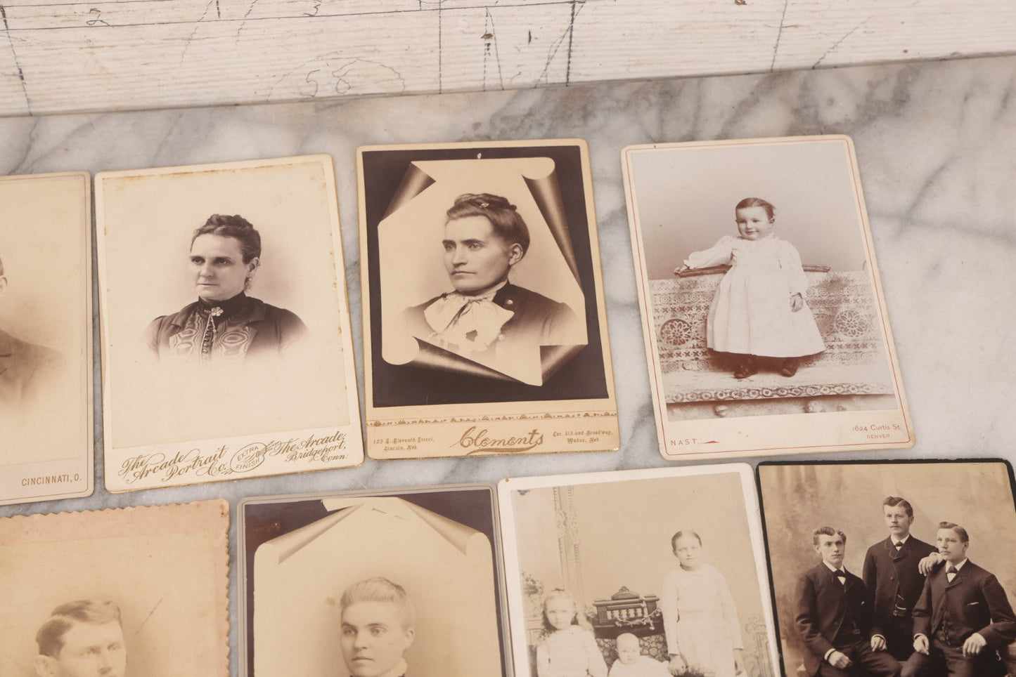 Lot 099 - Grouping Of 19 Antique Cabinet Card Photographs Including Cute Smiling Baby, Three Well Dressed Young Men, And Woman Posing With Photo Album