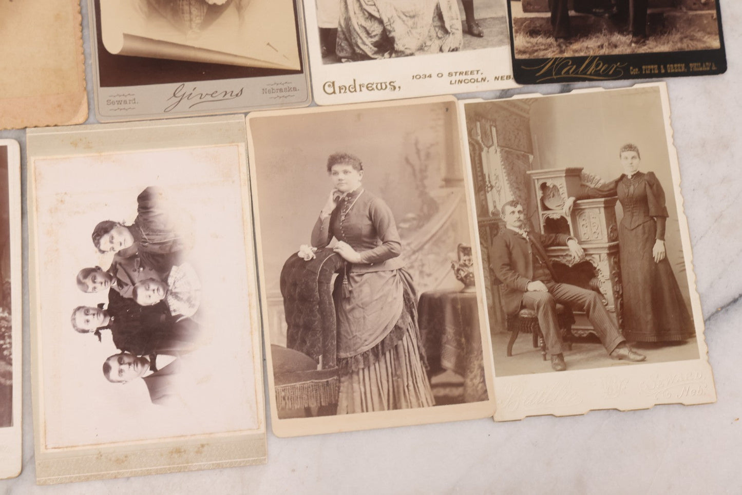Lot 099 - Grouping Of 19 Antique Cabinet Card Photographs Including Cute Smiling Baby, Three Well Dressed Young Men, And Woman Posing With Photo Album