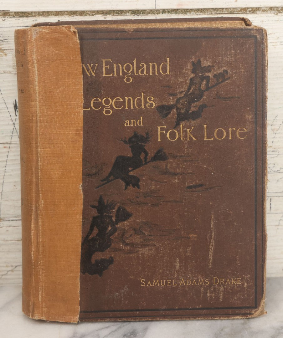 Lot 001 - "New England Legends And Folk Lore In Prose And Poetry" Antique Book By Samuel Adams Drake, Illustrated By F.T. Merrill With Witches On Broomsticks On Cover, Roberts Brothers, Publishers, Boston, 1884, Note Tape On Spine