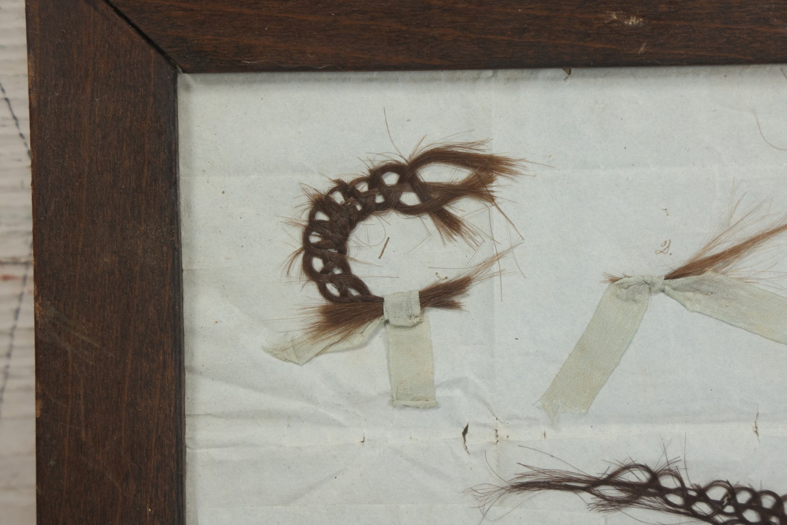 Lot 002 - Antique Victorian Hair Memento Scrap Page With Four Pieces Of Hair Work And Identification Legend, Hair Of Thankful, Josiah, And Ogden Hall, In Frame, 9-3/4" x 7-1/2"