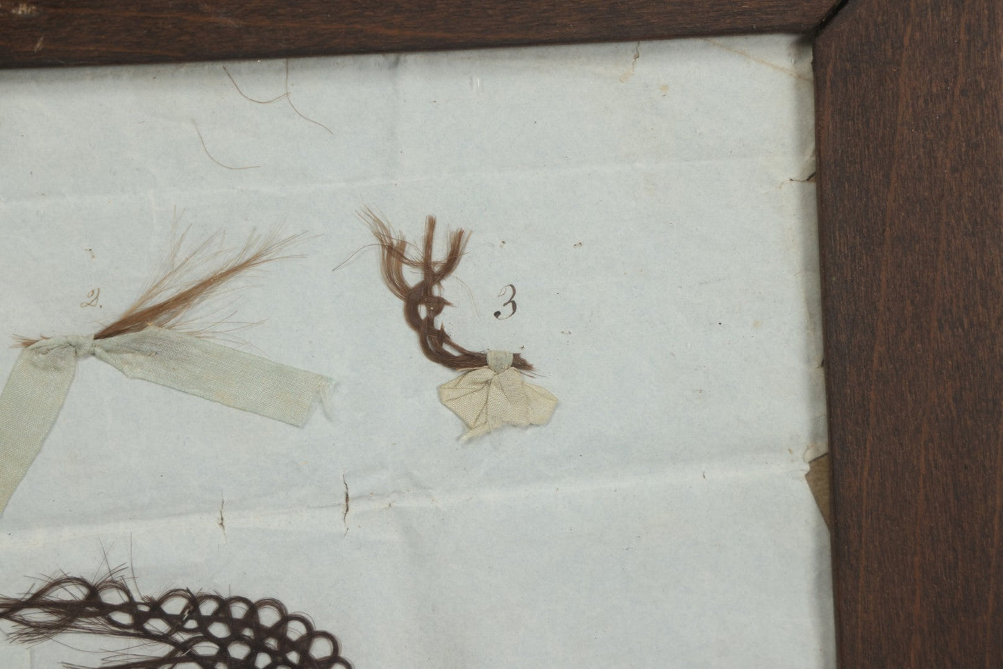 Lot 002 - Antique Victorian Hair Memento Scrap Page With Four Pieces Of Hair Work And Identification Legend, Hair Of Thankful, Josiah, And Ogden Hall, In Frame, 9-3/4" x 7-1/2"