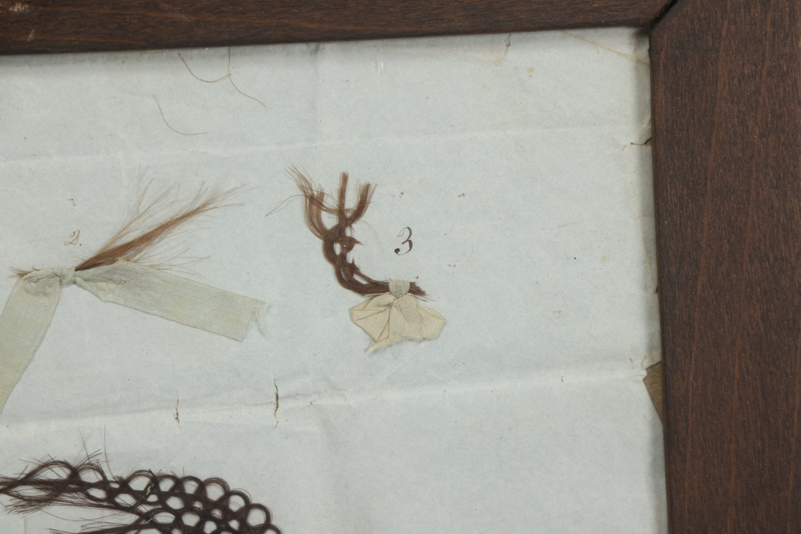 Lot 002 - Antique Victorian Hair Memento Scrap Page With Four Pieces Of Hair Work And Identification Legend, Hair Of Thankful, Josiah, And Ogden Hall, In Frame, 9-3/4" x 7-1/2"
