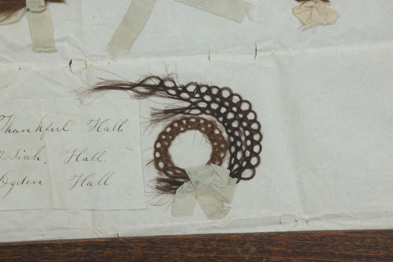 Lot 002 - Antique Victorian Hair Memento Scrap Page With Four Pieces Of Hair Work And Identification Legend, Hair Of Thankful, Josiah, And Ogden Hall, In Frame, 9-3/4" x 7-1/2"