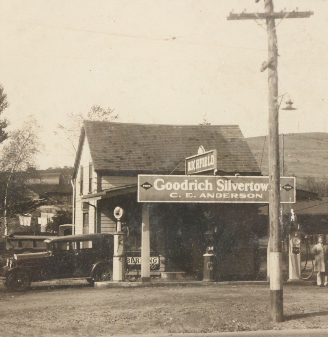 Lot 118 - Antique Boarded Photograph Of Early Gas Station With Many Automobiles Visible, Sign For Goodrich Silvertown Tires, C.E. Anderson, Richfield, In Frame, As Found, 13-3/4" x 11-1/4"