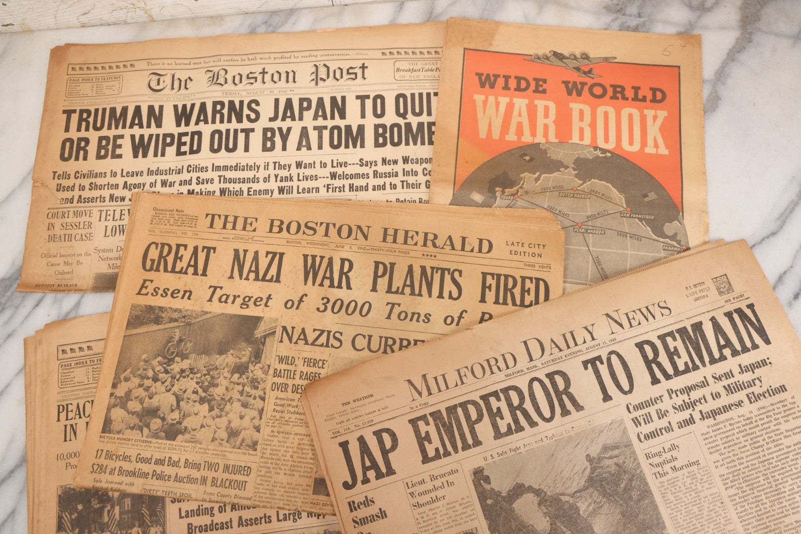 Lot 119 - Grouping Of Six World War Two Era Newspapers From The Boston Metro Area Reporting On Events From During And After The War Against Both The Germans And Japanese, With August 1945 Reporting On Use Of Atom Bomb, Dated 1942 Through 1945