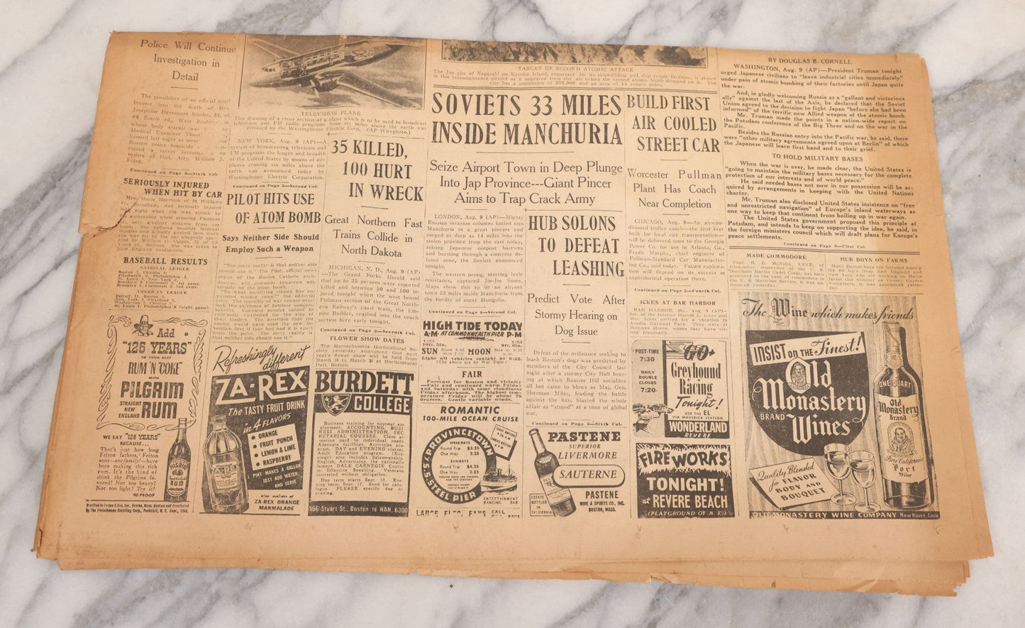 Lot 119 - Grouping Of Six World War Two Era Newspapers From The Boston Metro Area Reporting On Events From During And After The War Against Both The Germans And Japanese, With August 1945 Reporting On Use Of Atom Bomb, Dated 1942 Through 1945