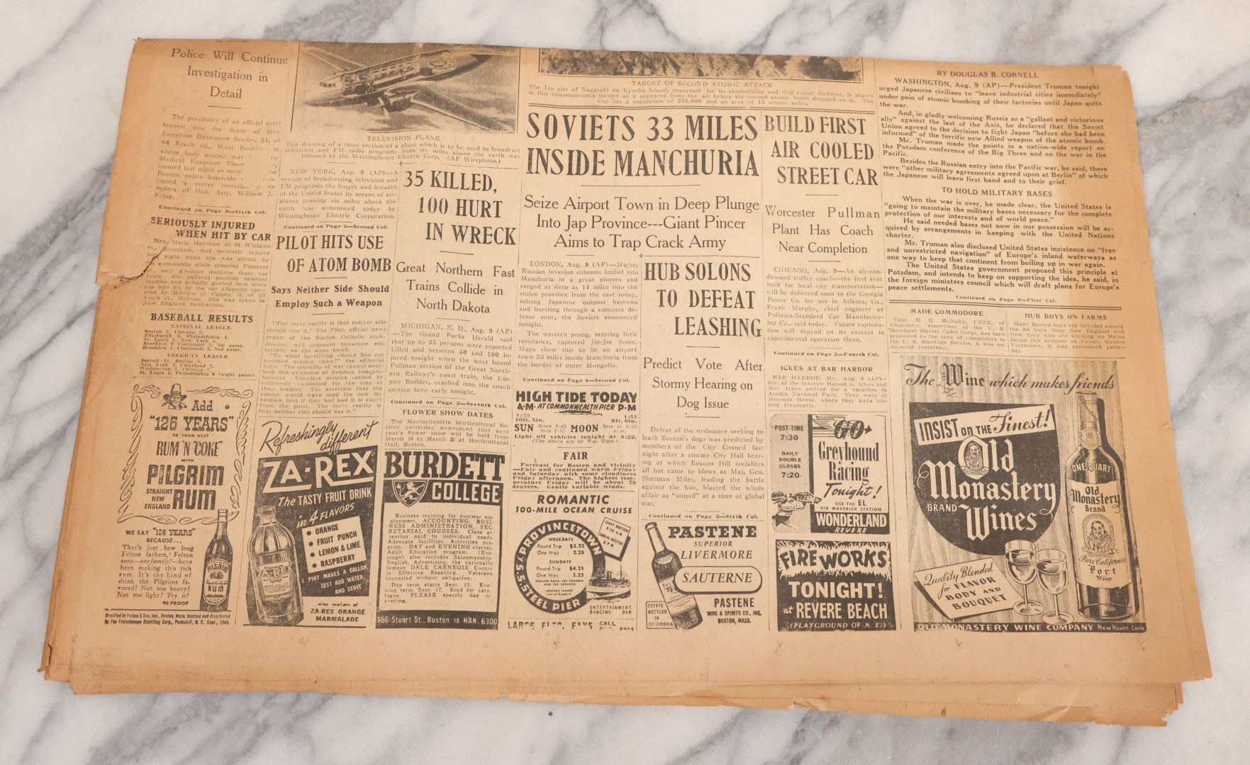 Lot 119 - Grouping Of Six World War Two Era Newspapers From The Boston Metro Area Reporting On Events From During And After The War Against Both The Germans And Japanese, With August 1945 Reporting On Use Of Atom Bomb, Dated 1942 Through 1945