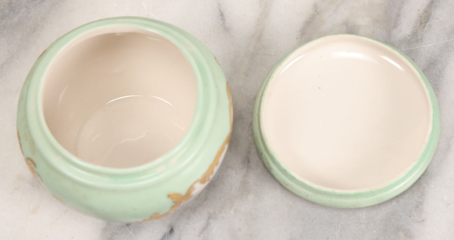 Lot 019 - Antique Hand Painted French Limoges Porcelain Dresser Box With Painting Of Brunette Woman In Extravagant Hat On Lid, With Yellow Painted Flowers, Artist Signed L.C.K. Dated 1894, With Purple "Belleek" Hallmark