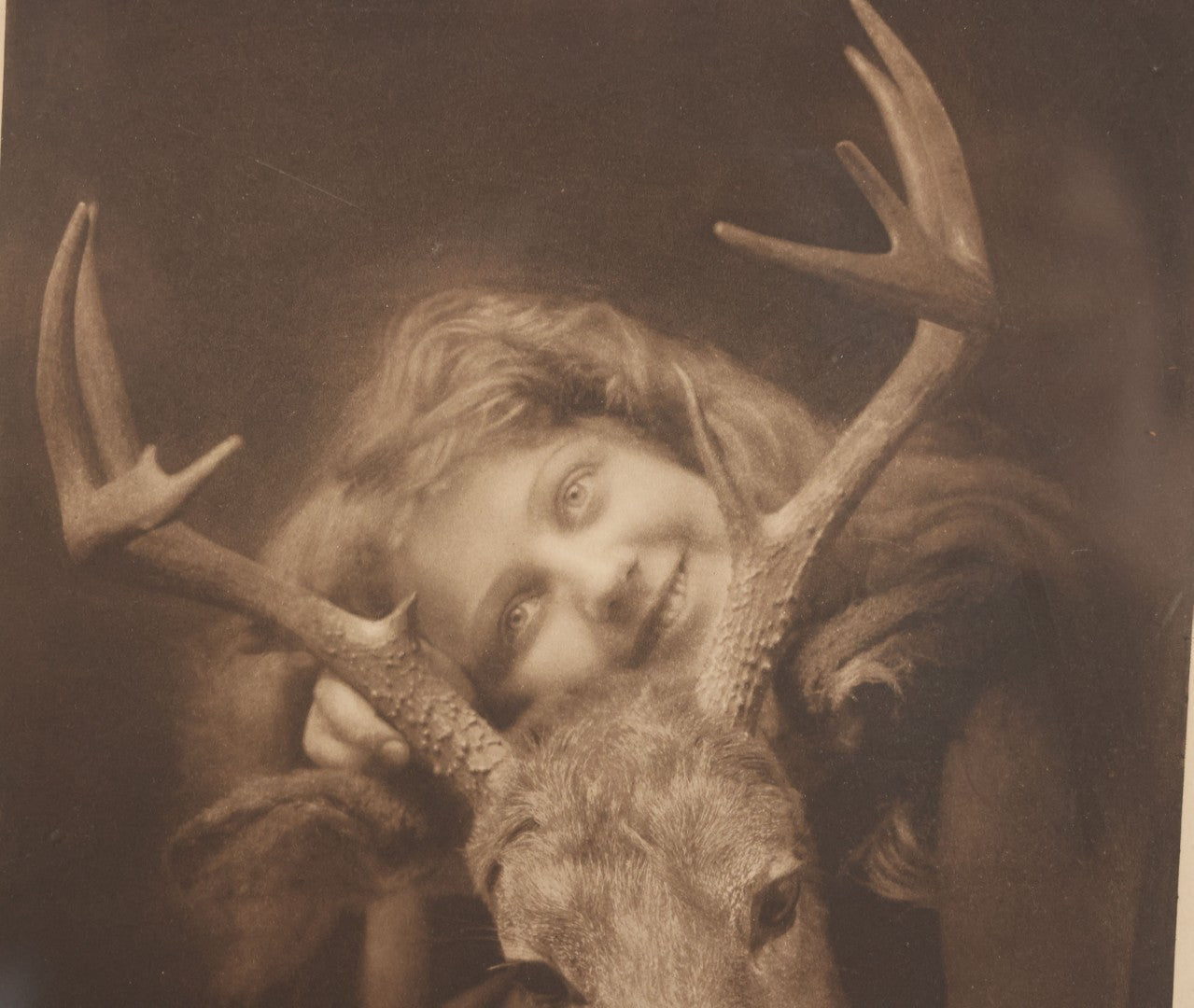 Lot 022 - Antique Comic Photographic Print Of Blissful Woman Hugging A Young Elk, "Oh! How I Love An Elk," Copyright 1907, Celebrity Art Co., Boston, 12-3/4" x 14-3/4"
