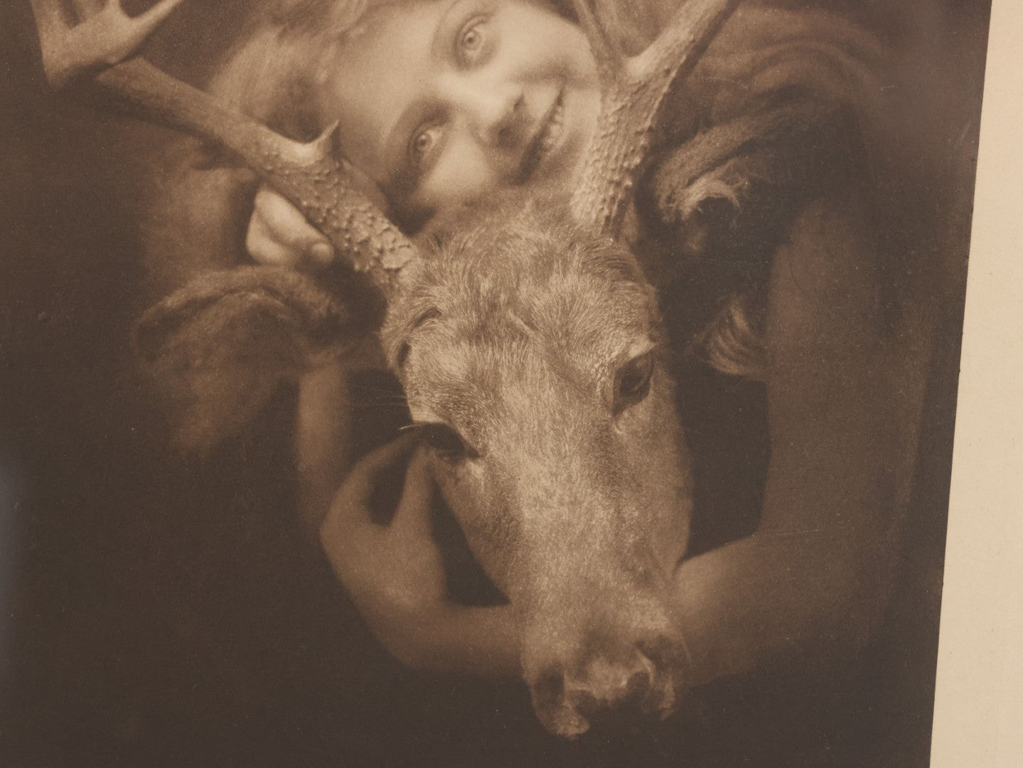 Lot 022 - Antique Comic Photographic Print Of Blissful Woman Hugging A Young Elk, "Oh! How I Love An Elk," Copyright 1907, Celebrity Art Co., Boston, 12-3/4" x 14-3/4"