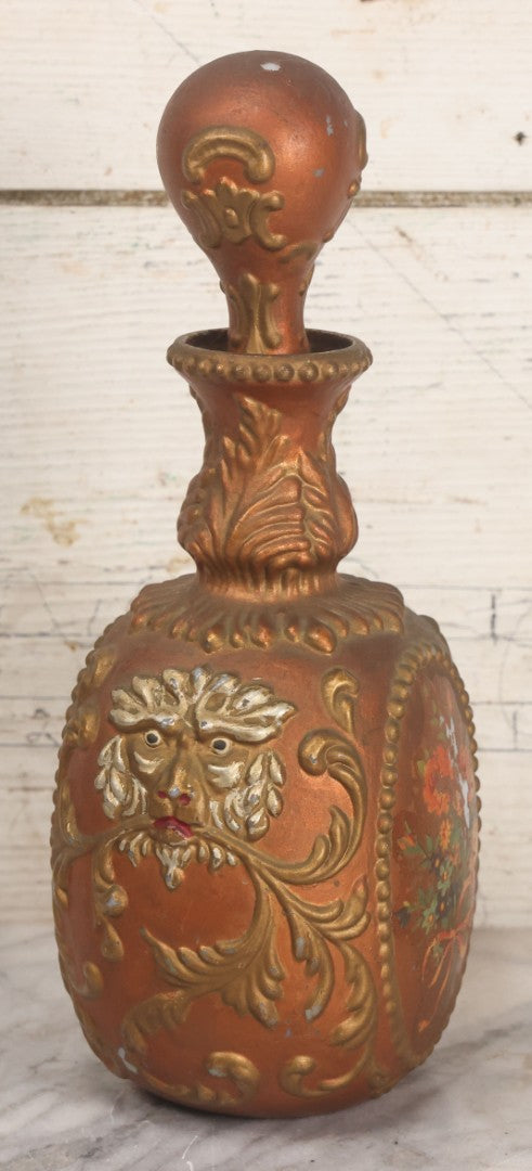 Lot 028 - Antique Hand Painted Baroque Renaissance Revival White Glass Decanter With Copper And Gold Paint, Ornate Grotesque Lion Mask Motif And Foliate Scrolls, Applied Flower Decal, And Original Matching Stopper, Circa 1900, 10-5/8" Height