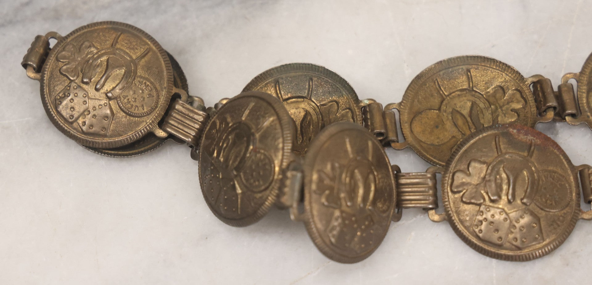 Lot 048 - Vintage Pressed Brass Good Luck Charm Necklace With Four Leaf Clover, Lucky Penny, Dice, Horseshoe, And Wishbone, With Fifteen Pressed "Coins"