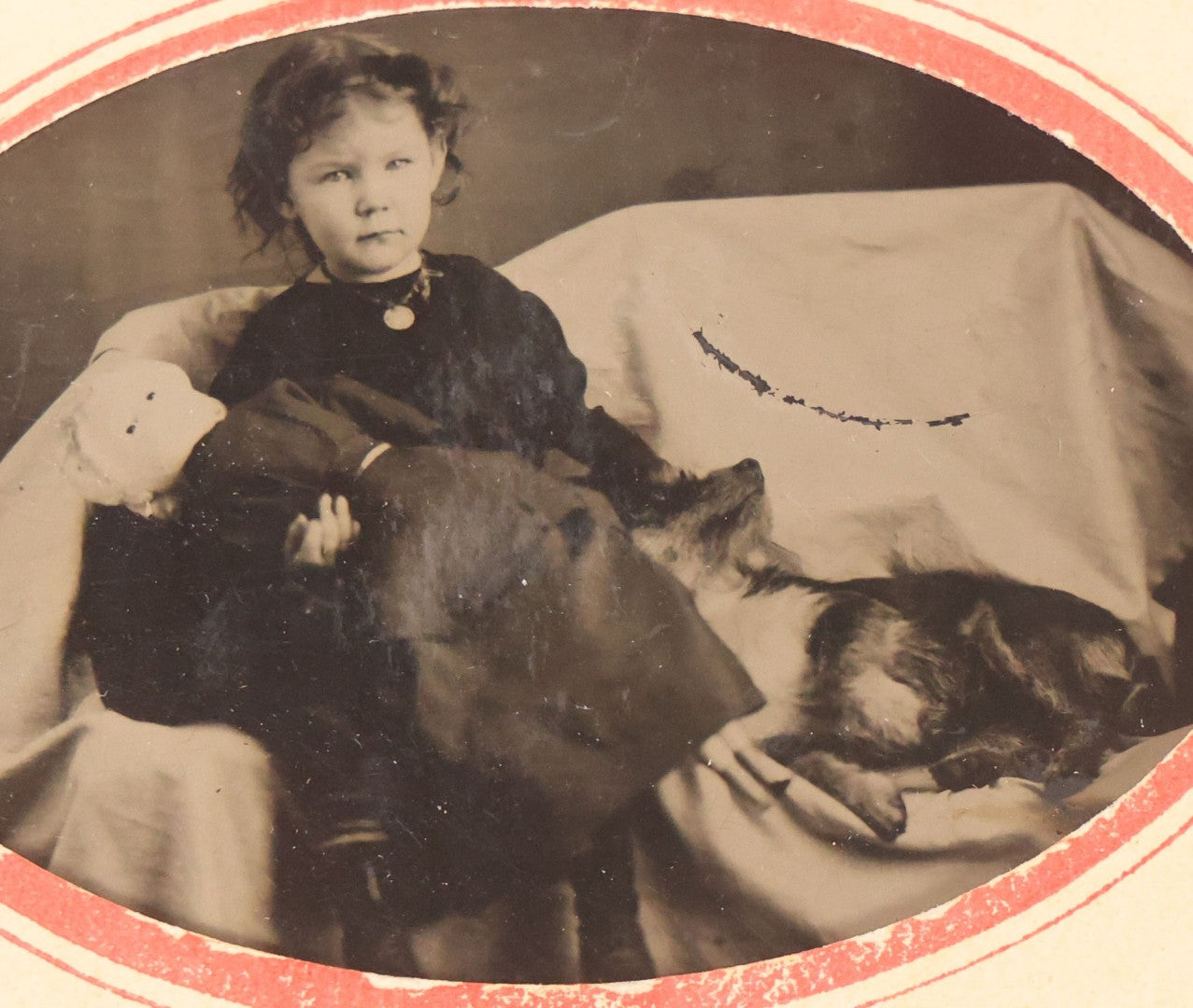 Lot 063 - Antique Tintype Photograph Of Little Girl Posing With Large Doll And Scraggly Little Dog, Photo In Landscape Orientation, In Paper Frame