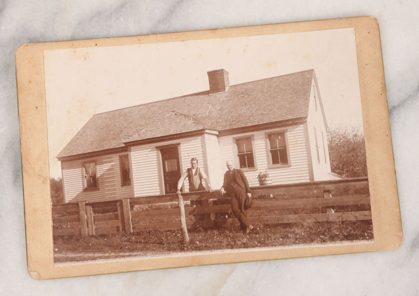 Lot 068 - Grouping Of Nine Antique Photographs Including Souvenir Tintype Of Young Boys In Overalls, Group Photo Of Family Posing Outside Large Farmhouse, Cabinet Cards, And More