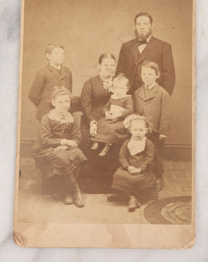 Lot 068 - Grouping Of Nine Antique Photographs Including Souvenir Tintype Of Young Boys In Overalls, Group Photo Of Family Posing Outside Large Farmhouse, Cabinet Cards, And More