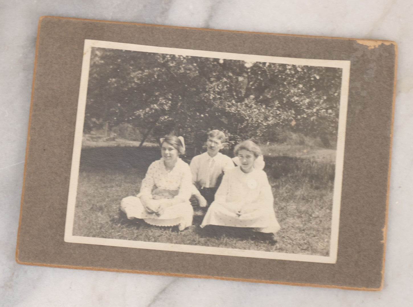 Lot 068 - Grouping Of Nine Antique Photographs Including Souvenir Tintype Of Young Boys In Overalls, Group Photo Of Family Posing Outside Large Farmhouse, Cabinet Cards, And More