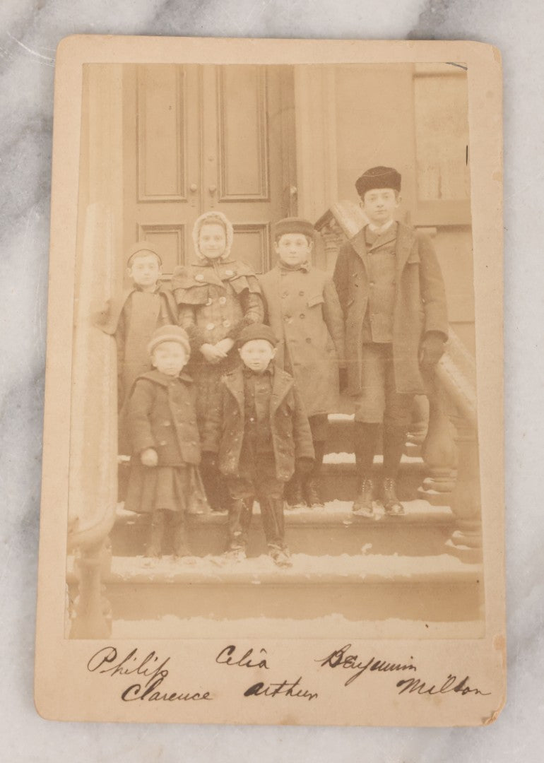 Lot 070 - Grouping Of Seven Antique Photographs Of Children, Including Makeshift Frame Of Girl In Four Views, Children Posing On New York City Stoop, Children In Cribs, Boy Posing With Toys